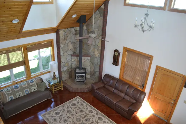 a view of a table chairs and an ocean in the background