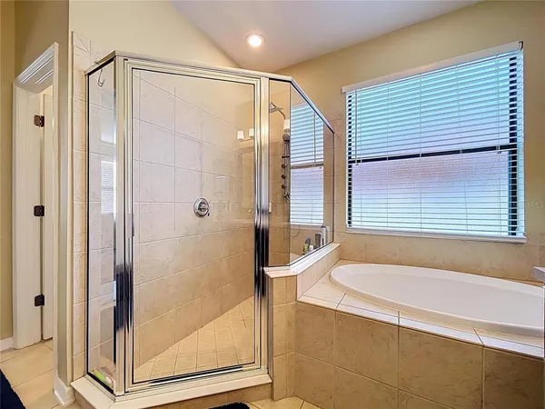 a bathroom with a bathtub and a shower