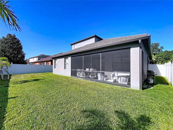 a view of a house with backyard and porch