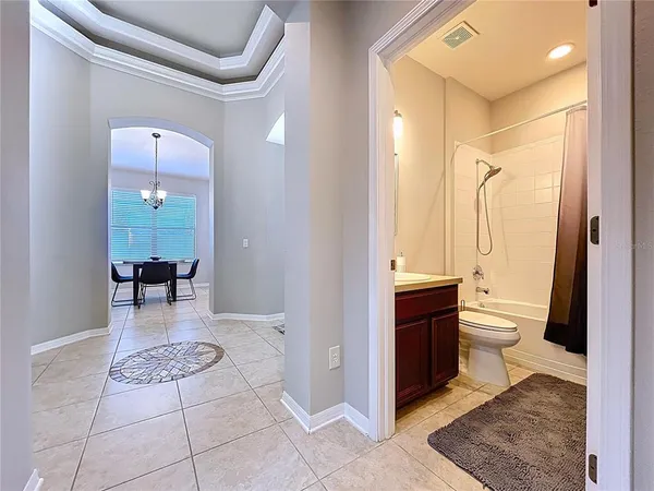 a bathroom with a granite countertop sink a toilet and a mirror