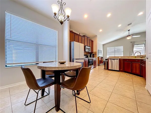 a view of a dining room with furniture and a chandelier