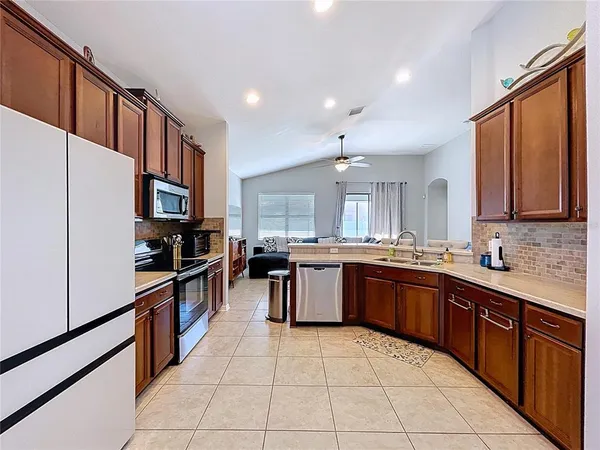 a large kitchen with stainless steel appliances lots of counter top space