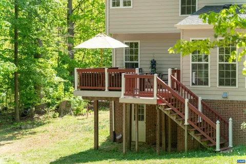 a view of house with yard and sitting area