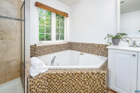 a bathroom with a bathtub and shower
