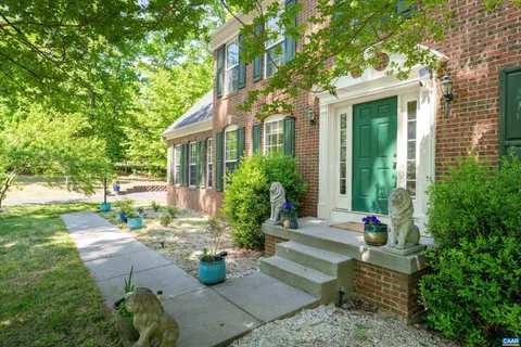 a view of a house with backyard sitting area and garden