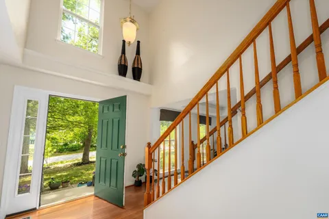 a view of staircase with wooden floor and a large window