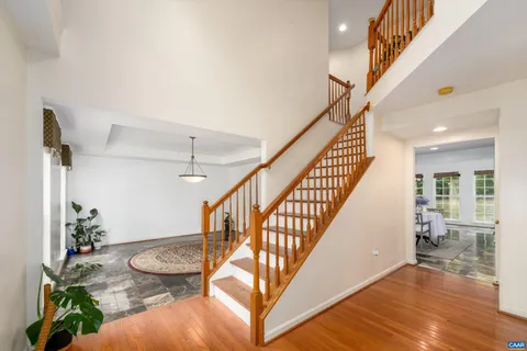 a view of entryway and hall with wooden floor