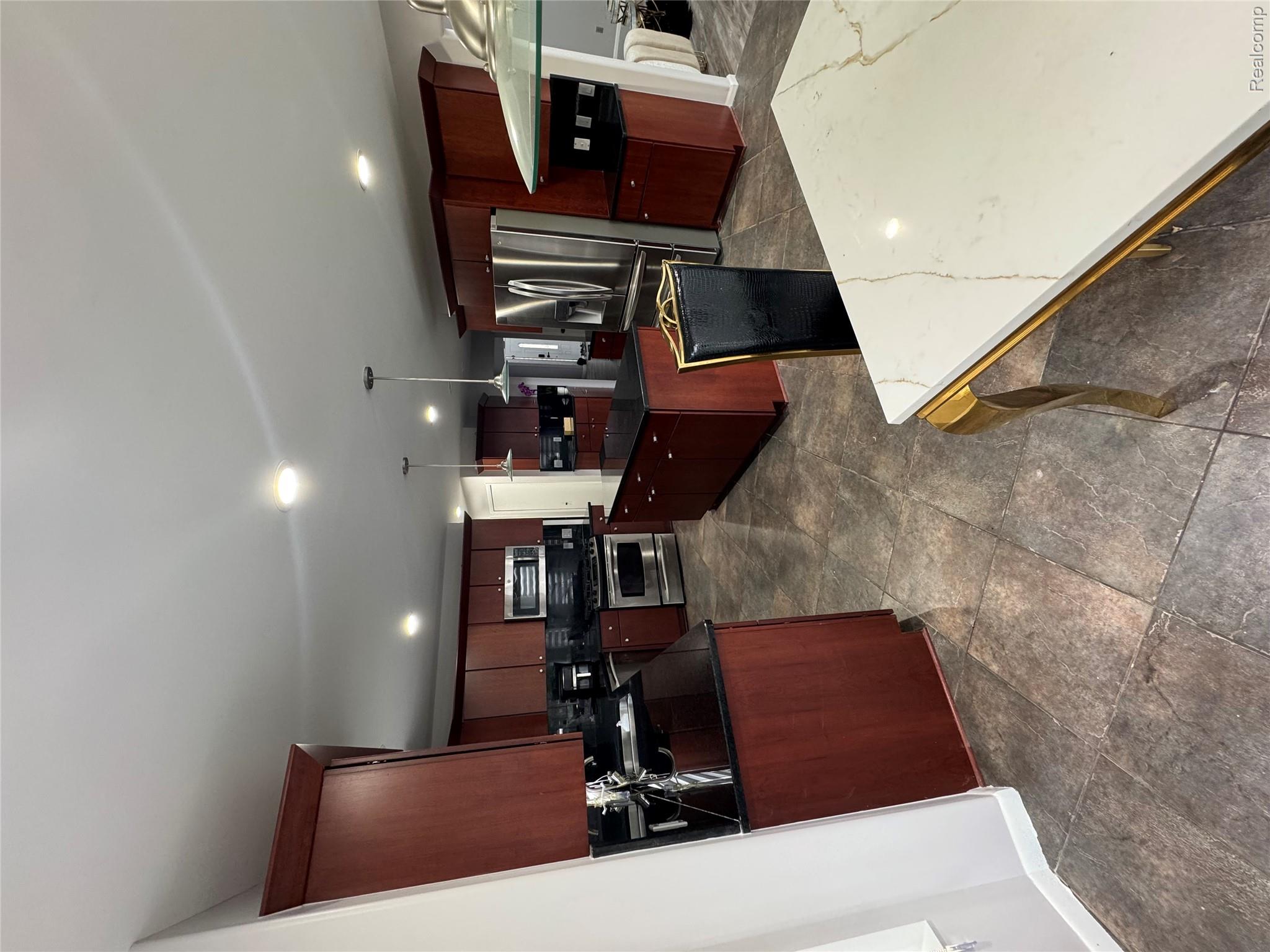 50493 Nesting Ridge Drive Macomb, MI 48044 - Photo 20 of 34 Kitchen with fridge, pendant lighting, range, a kitchen island, and backsplash