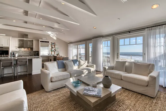 a living room with furniture wooden floor and a large window