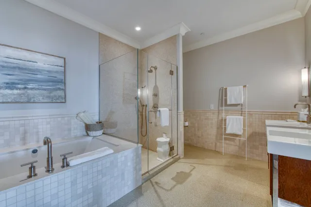 a bathroom with a tub shower and sink