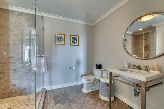 a bathroom with a sink toilet and shower