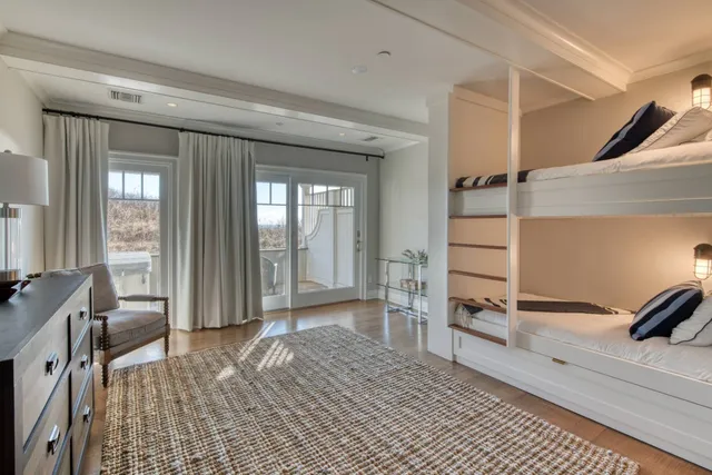 a view of a bedroom with furniture and windows