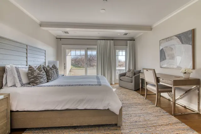 a bedroom with a large bed and a chandelier