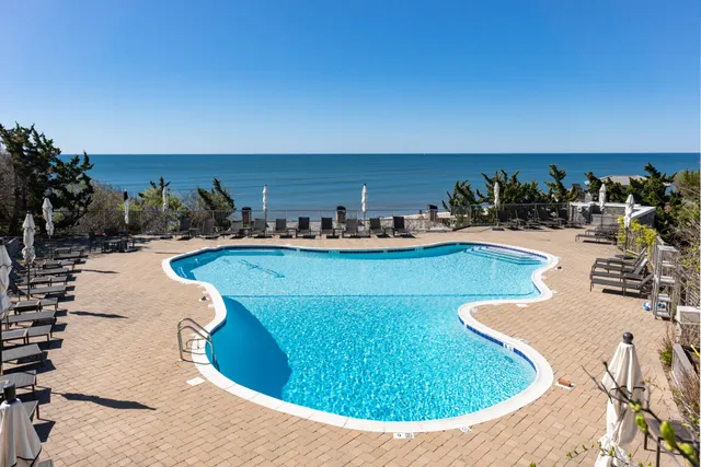a view of a swimming pool with outdoor seating