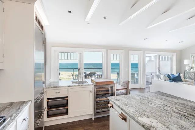 a large kitchen with sink stove and cabinets