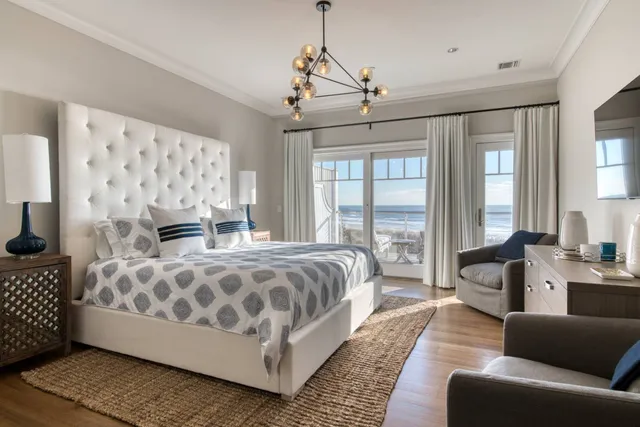 a spacious bedroom with a bed a couch and dresser