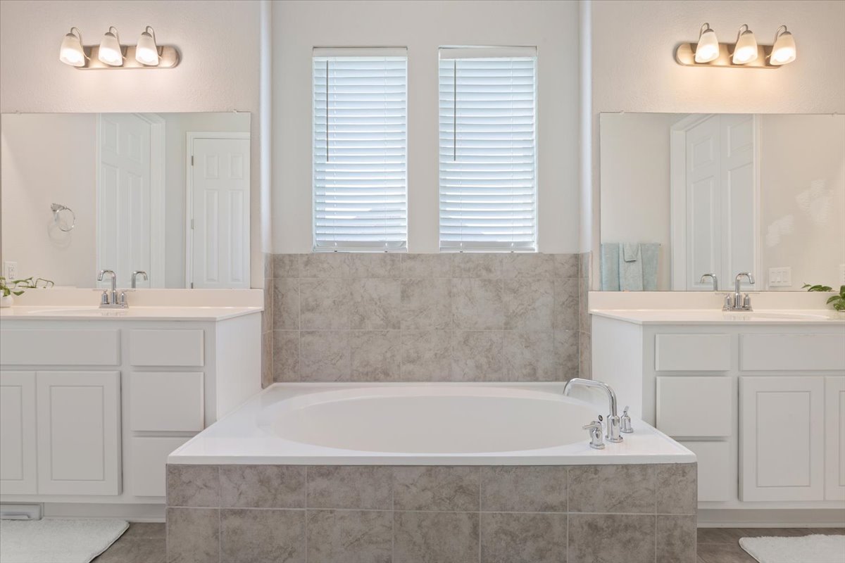 3625 Garrano Bend Leander, TX 78641 - Photo 17 of 38 Indulge in a tranquil retreat with a deep-soaking tub and twin vanities for ultimate relaxation.