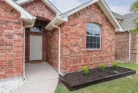a view of front door of a house with plants