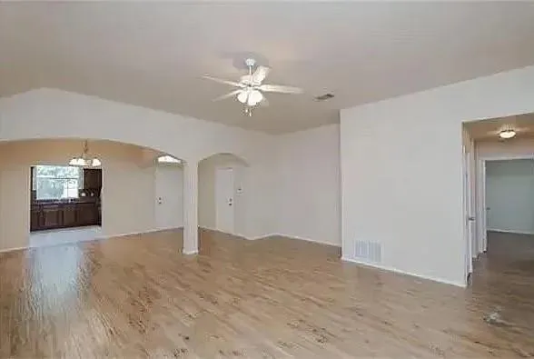 a view of an empty room with wooden walls