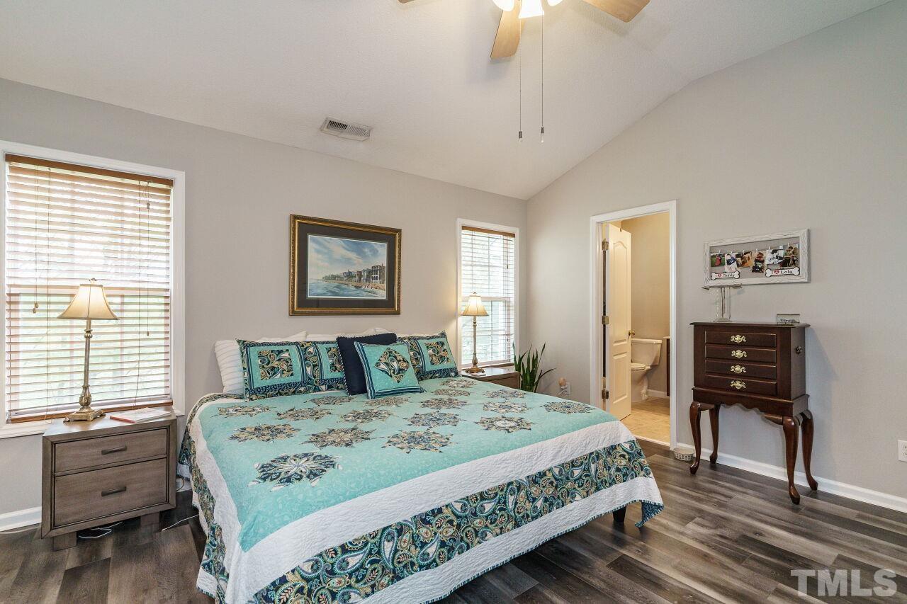 6903 Middleboro Drive Raleigh, NC 27612 - Photo 17 of 26 a bedroom with a bed and a table
