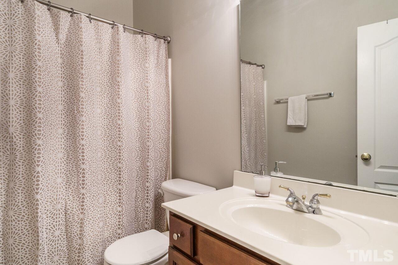 6903 Middleboro Drive Raleigh, NC 27612 - Photo 21 of 26 a bathroom with a sink toilet and shower