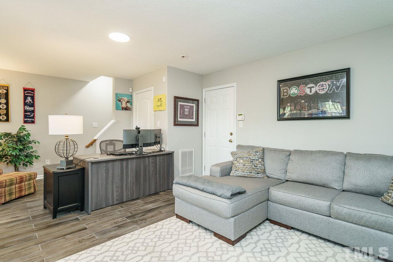 6903 Middleboro Drive Raleigh, NC 27612 - Photo 23 of 26 a living room with furniture and painting on the wall
