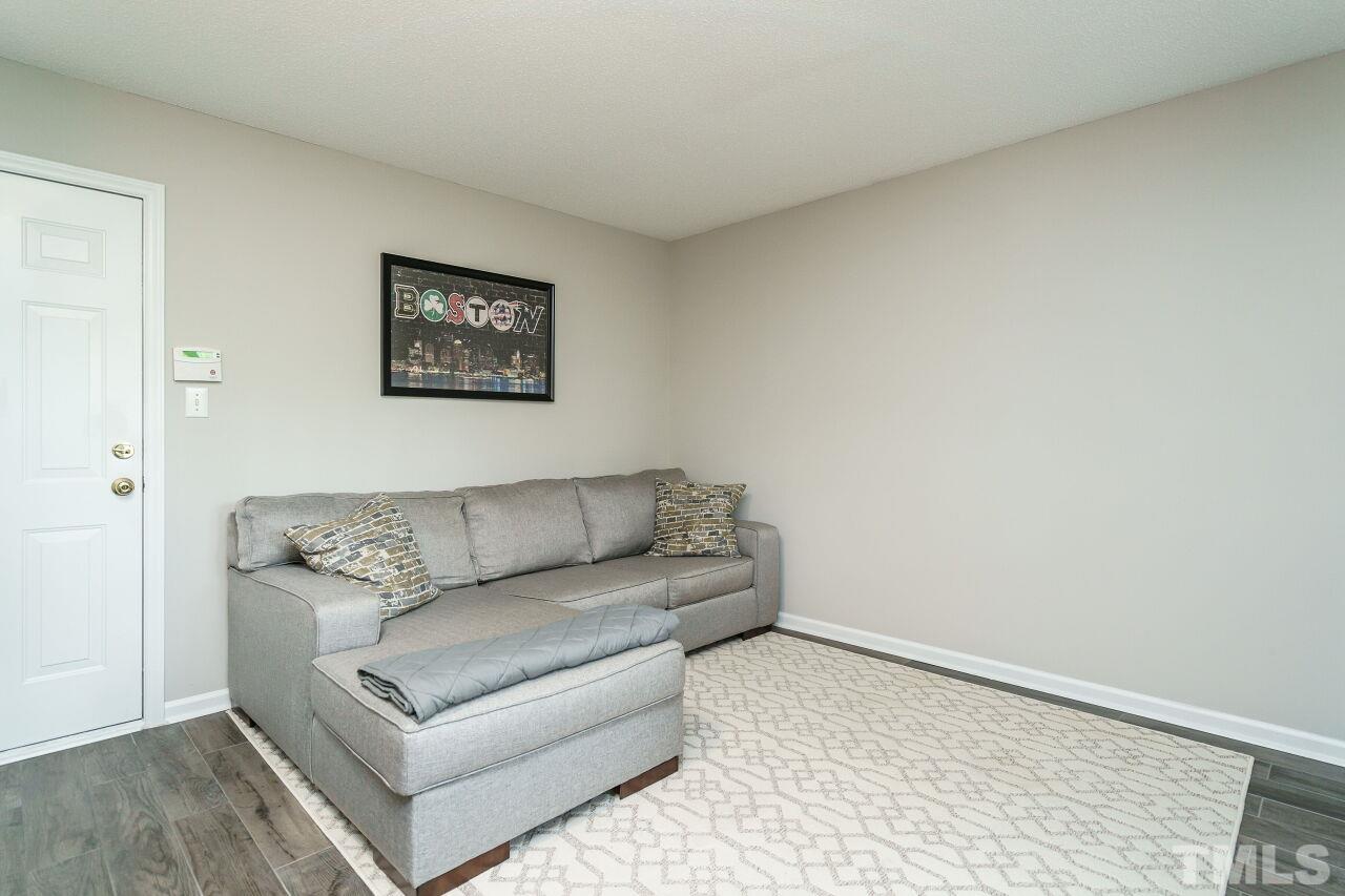 6903 Middleboro Drive Raleigh, NC 27612 - Photo 24 of 26 a living room with a couch and a coffee table