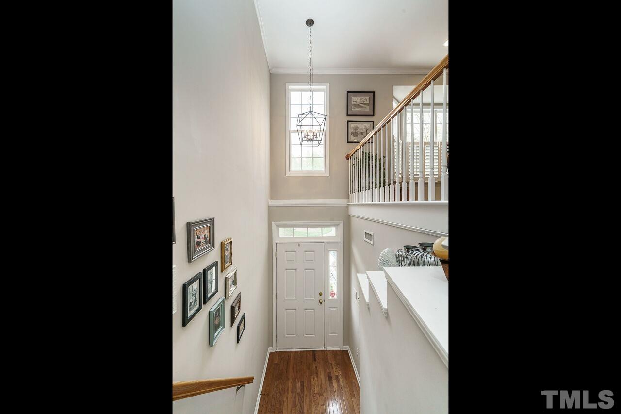 6903 Middleboro Drive Raleigh, NC 27612 - Photo 3 of 26 a view of a hallway with wooden floor and staircase