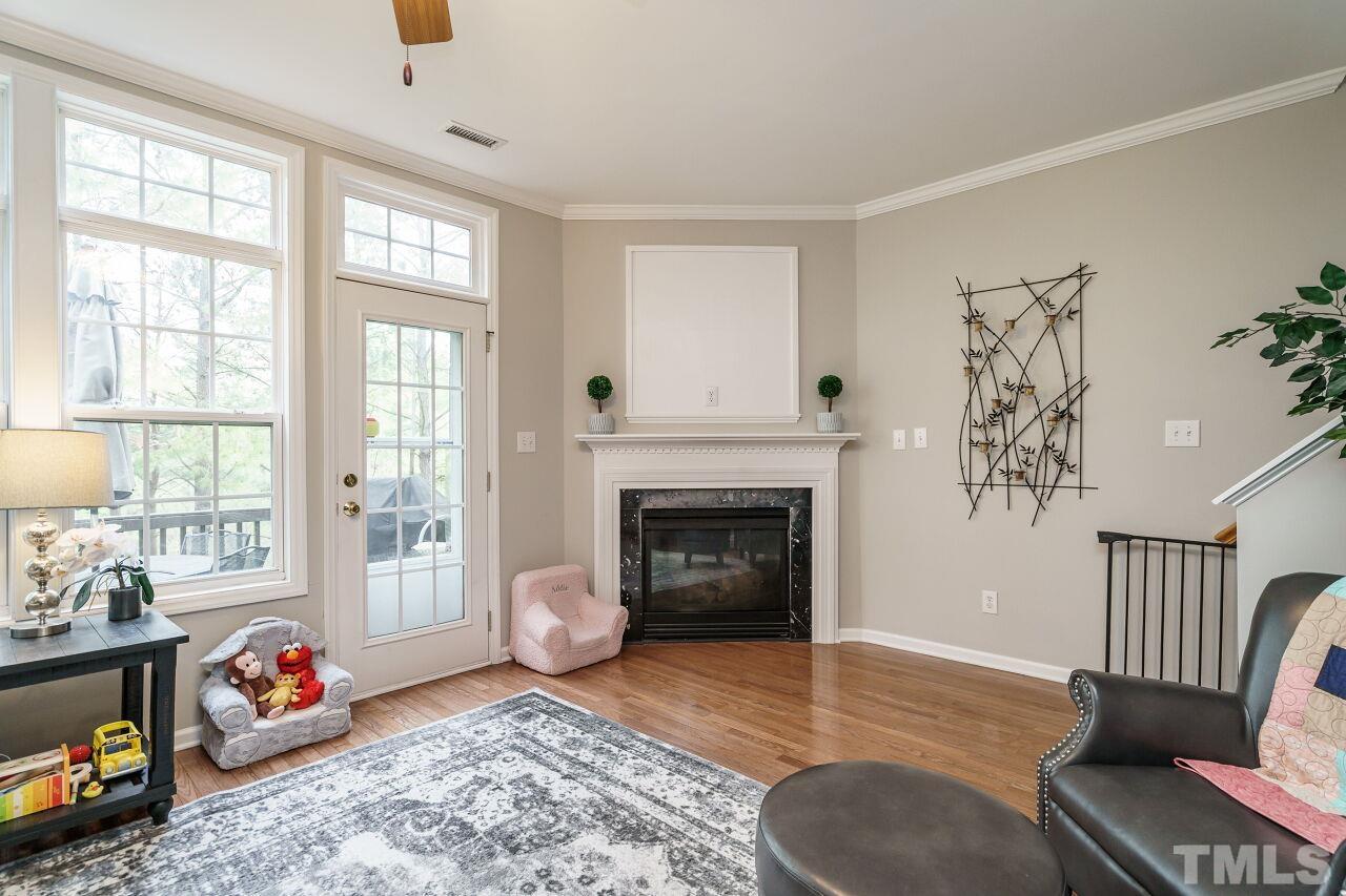 6903 Middleboro Drive Raleigh, NC 27612 - Photo 7 of 26 a living room with furniture and a fireplace