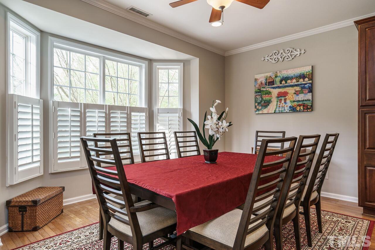 6903 Middleboro Drive Raleigh, NC 27612 - Photo 9 of 26 a view of a dining room with furniture window and wooden floor
