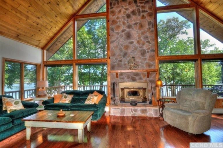 33 Golf Course Road Copake, NY 12521 - Photo 6 of 10 a living room with furniture a fireplace and a large window