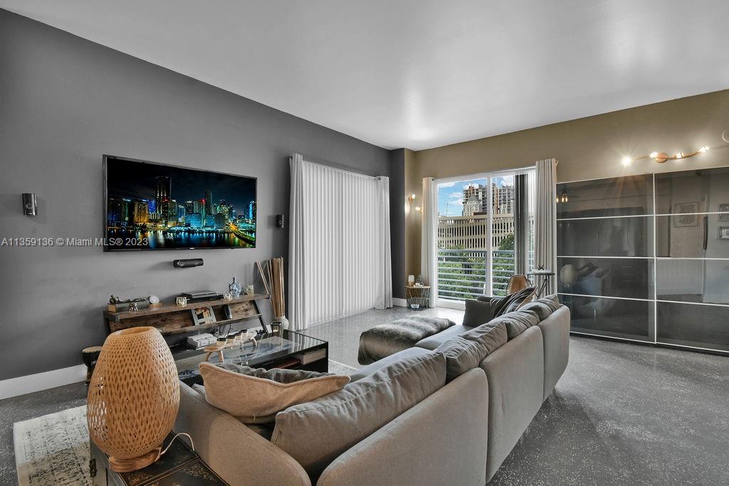 234 Northeast 3rd Street, Unit 507 Miami, FL 33132 - Photo 12 of 48 a living room with furniture and a flat screen tv