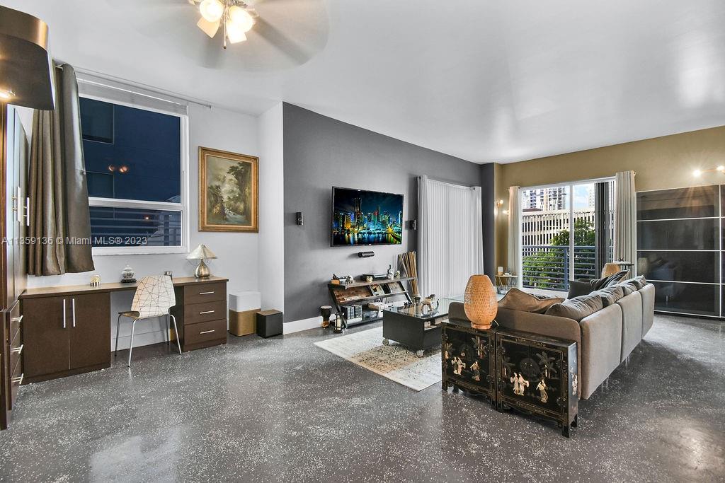 234 Northeast 3rd Street, Unit 507 Miami, FL 33132 - Photo 13 of 48 a living room with furniture and a flat screen tv