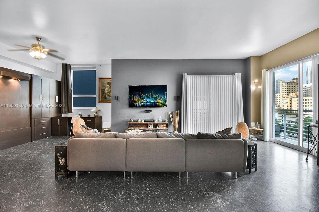 234 Northeast 3rd Street, Unit 507 Miami, FL 33132 - Photo 14 of 48 a living room with furniture and a flat screen tv