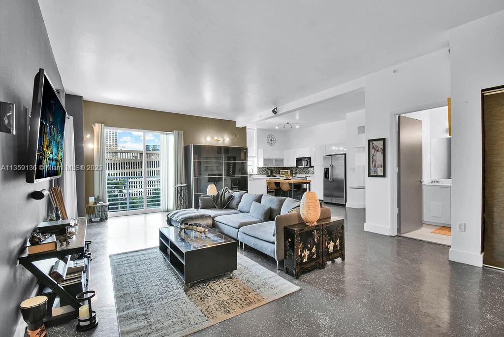 234 Northeast 3rd Street, Unit 507 Miami, FL 33132 - Photo 15 of 48 a living room with furniture floor to ceiling window and flat screen tv