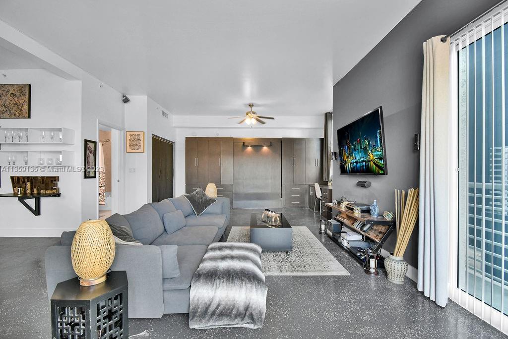 234 Northeast 3rd Street, Unit 507 Miami, FL 33132 - Photo 16 of 48 a living room with furniture and a flat screen tv