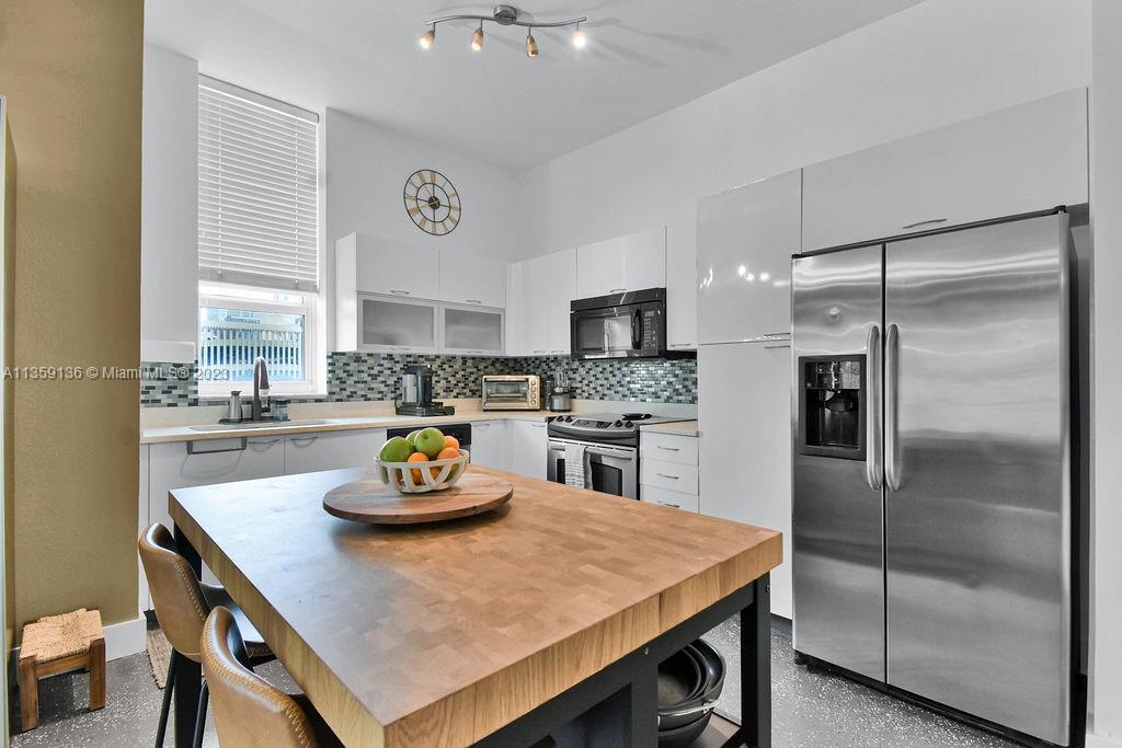 234 Northeast 3rd Street, Unit 507 Miami, FL 33132 - Photo 20 of 48 a kitchen with a refrigerator a sink and a refrigerator