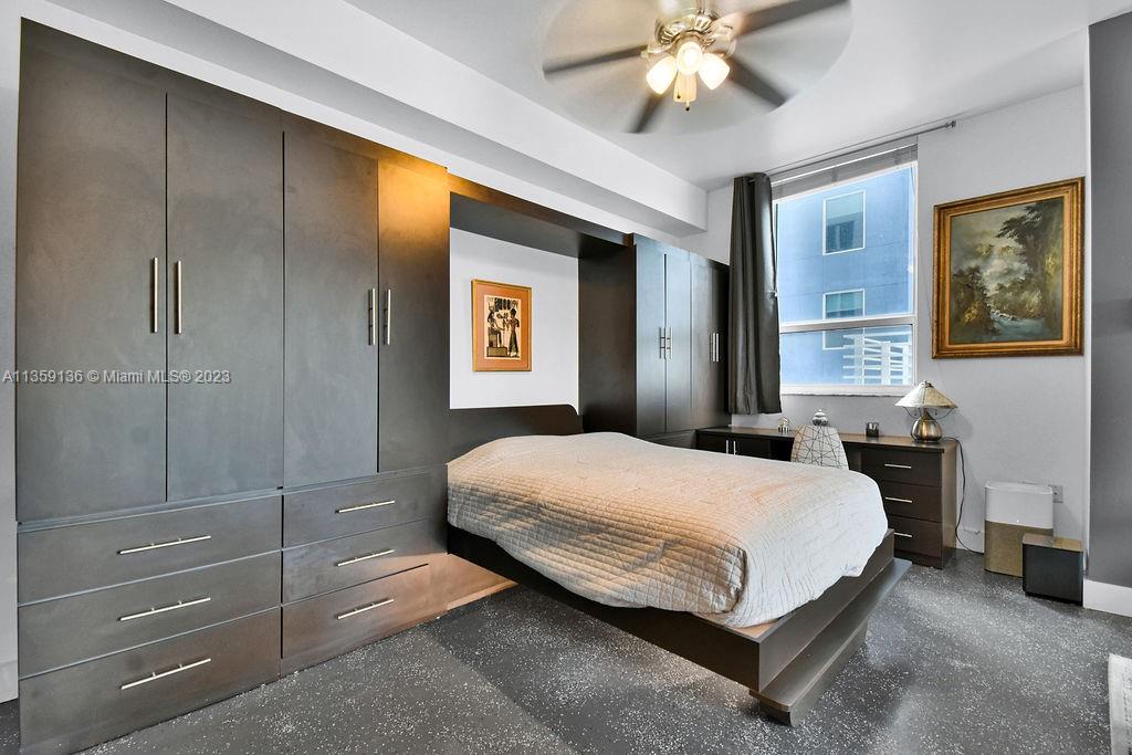 234 Northeast 3rd Street, Unit 507 Miami, FL 33132 - Photo 23 of 48 a bedroom with a bed and a chandelier