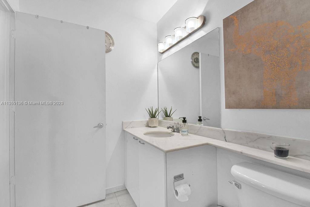 234 Northeast 3rd Street, Unit 507 Miami, FL 33132 - Photo 25 of 48 a bathroom with a sink and a mirror