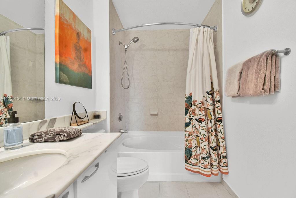 234 Northeast 3rd Street, Unit 507 Miami, FL 33132 - Photo 26 of 48 a bathroom with a granite countertop sink and a mirror