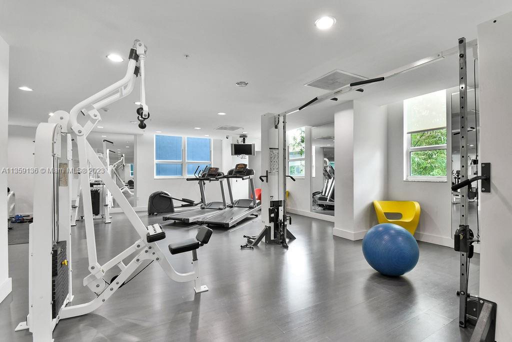 234 Northeast 3rd Street, Unit 507 Miami, FL 33132 - Photo 38 of 48 a living room with furniture kitchen view and a wooden floor