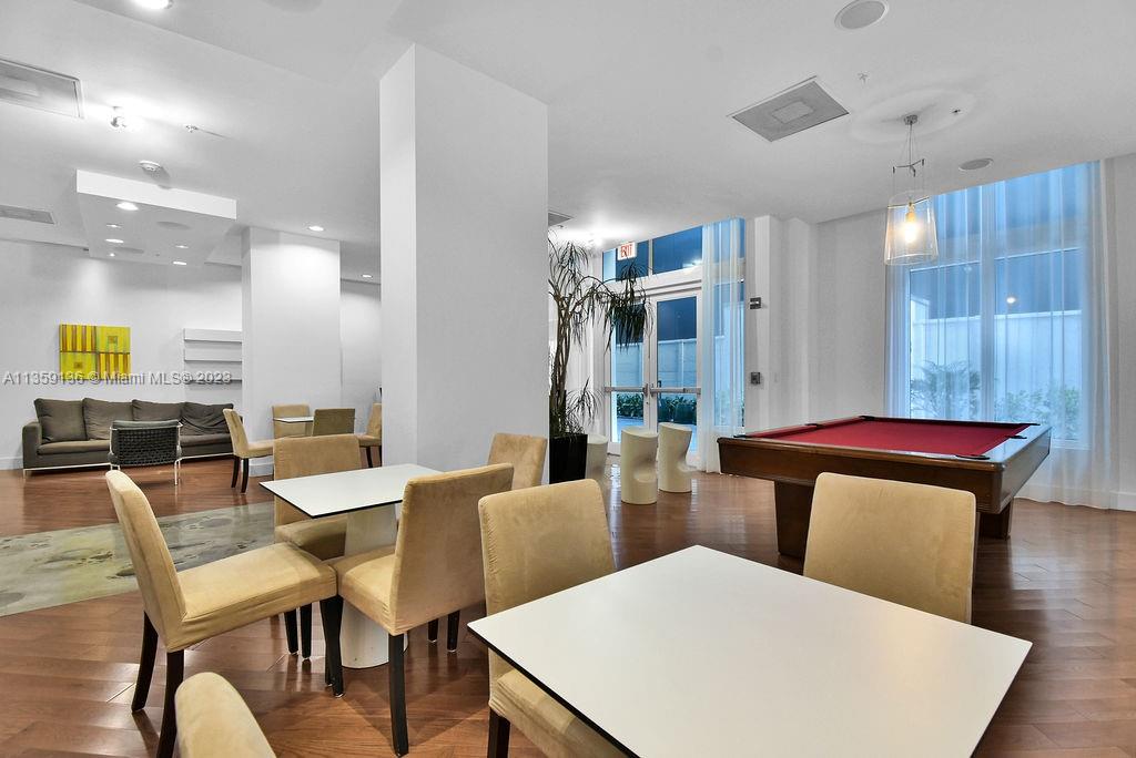 234 Northeast 3rd Street, Unit 507 Miami, FL 33132 - Photo 43 of 48 a view of a dining room with furniture and wooden floor