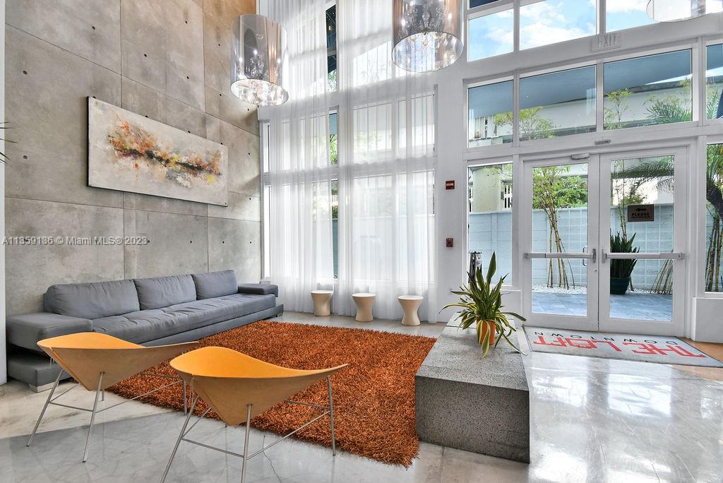 234 Northeast 3rd Street, Unit 507 Miami, FL 33132 - Photo 5 of 48 a living room with furniture and a large window