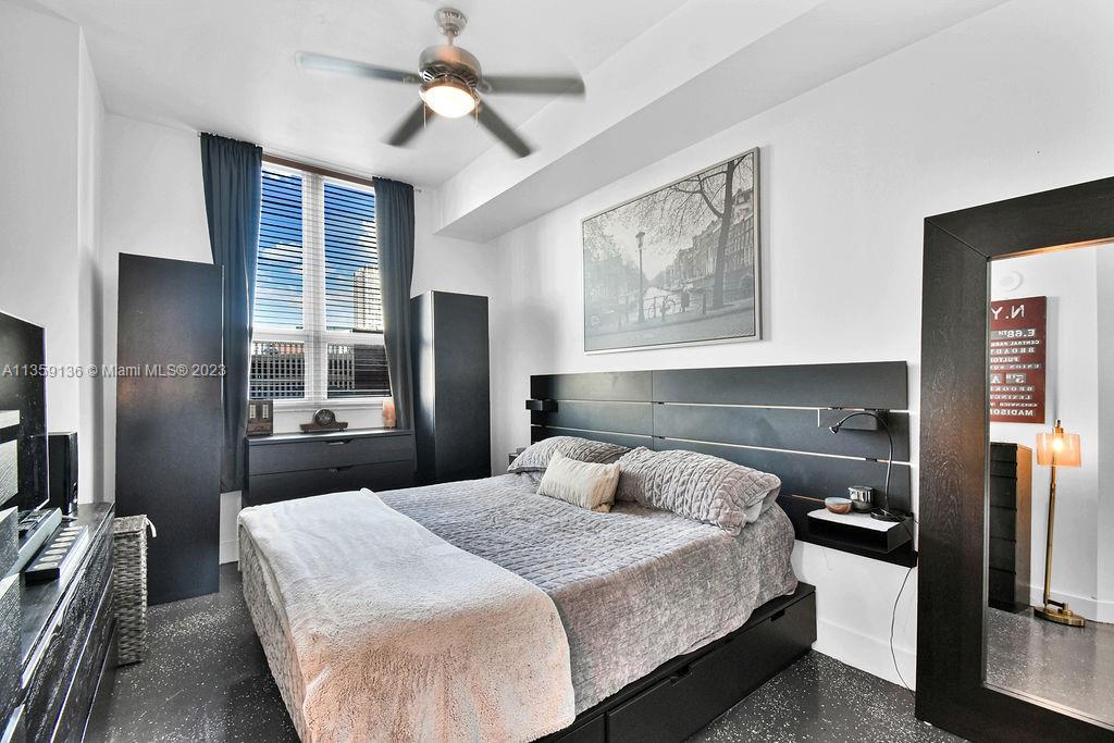 234 Northeast 3rd Street, Unit 507 Miami, FL 33132 - Photo 7 of 48 a bedroom with a bed and a chandelier