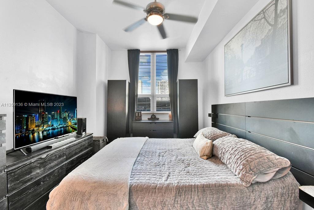 234 Northeast 3rd Street, Unit 507 Miami, FL 33132 - Photo 8 of 48 a bedroom with a bed and a flat screen tv