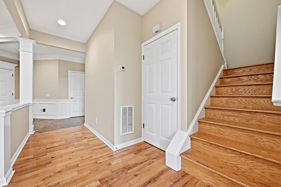 8761 Cascade Road Breinigsville, PA 18031 - Photo 39 of 84 A welcoming entry foyer features warm hardwood floors and wainscoting, leading to a natural wood staircase.