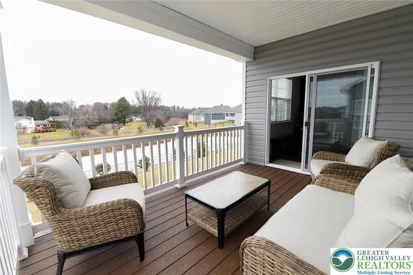 a balcony with furniture and a wooden floor