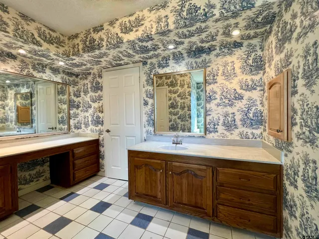 a bathroom with a sink and a large mirror