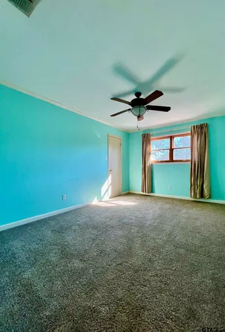 a view of a livingroom with a fireplace and a ceiling fan