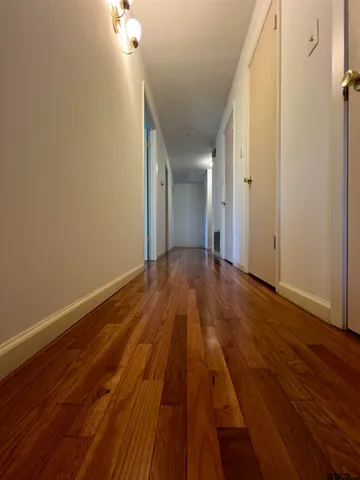 a view of a room with wooden floor
